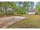 Wide shot of backyard basketball court and the house with patio and brick wall at 1729 Longleaf Dr., Myrtle Beach, SC 29575
