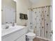Well-lit bathroom featuring a single vanity and shower-tub combo with a charming curtain at 1729 Longleaf Dr., Myrtle Beach, SC 29575
