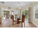 Bright dining area with large windows, chandelier, and views of the backyard and living room at 1729 Longleaf Dr., Myrtle Beach, SC 29575