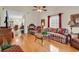 Cozy living room with hardwood floors, ceiling fan, and large windows for natural light at 1729 Longleaf Dr., Myrtle Beach, SC 29575