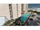 Stunning aerial view showcasing the building, pools, lush landscaping, and ocean proximity at 200 76Th Ave. N # 301, Myrtle Beach, SC 29572