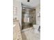 This bathroom features a glass shower door with tile and stone accents and a light granite countertop at 200 76Th Ave. N # 301, Myrtle Beach, SC 29572