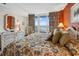 Well-lit bedroom with ocean view and floral bedding at 200 76Th Ave. N # 301, Myrtle Beach, SC 29572