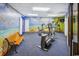 The fitness area has cardio equipment and a bench near wall art of a beach scene at 200 76Th Ave. N # 301, Myrtle Beach, SC 29572