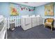 Community laundry room features washers and dryers in a colorful, well-lit space at 200 76Th Ave. N # 301, Myrtle Beach, SC 29572