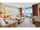 Comfortable living room with couches, large sliding glass doors, and an ocean view balcony at 200 76Th Ave. N # 301, Myrtle Beach, SC 29572