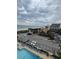 Aerial view showcasing the complex, nearby parking, ocean, and community pool at 200 76Th Ave. N # 608, Myrtle Beach, SC 29572