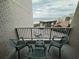 Cozy balcony with chairs and a table, overlooking the ocean and nearby buildings at 200 76Th Ave. N # 608, Myrtle Beach, SC 29572