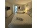 Bright bedroom featuring two queen beds with white linens, tiled floors, and a view of the balcony at 200 76Th Ave. N # 608, Myrtle Beach, SC 29572