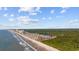 Aerial view showing resort condo building, ocean, beach, and trees at 200 Lands End Blvd. # 3015, Myrtle Beach, SC 29572