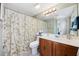Well-lit bathroom featuring a vanity with double sinks, large mirror, and shower with bamboo curtain at 200 Lands End Blvd. # 3015, Myrtle Beach, SC 29572