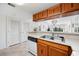 The kitchen area has wooden cabinets, tile floors, and a view into the living room area and sliding doors at 200 Lands End Blvd. # 3015, Myrtle Beach, SC 29572