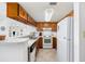 Well-equipped kitchen with wood cabinetry, tile flooring and white appliances including a refrigerator and oven at 200 Lands End Blvd. # 3015, Myrtle Beach, SC 29572