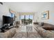 Cozy living room with sliding doors offering picturesque views of the outside trees and landscaping at 200 Lands End Blvd. # 3015, Myrtle Beach, SC 29572
