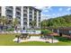 Exterior of condo building with a community pool, picnic tables, and lounge chairs at 200 Lands End Blvd. # 3015, Myrtle Beach, SC 29572
