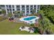 Aerial view of a community pool and jacuzzi surrounded by lounge chairs and palm trees at 200 Lands End Blvd. # 3015, Myrtle Beach, SC 29572