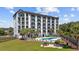 Condo exterior featuring an in-ground pool, lounge furniture, and well-manicured landscaping at 200 Lands End Blvd. # 3015, Myrtle Beach, SC 29572