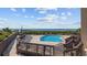 Community pool with lounge chairs and a wooden deck overlooking the beach at 200 Lands End Blvd. # 3015, Myrtle Beach, SC 29572