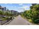 View of gated community street, residences, landscaping, and palm trees at 200 Lands End Blvd. # 3015, Myrtle Beach, SC 29572