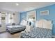 Bright bedroom featuring two beds, blue walls, and a decorative mirror above the nightstand at 209 75Th Ave N # T-8, Myrtle Beach, SC 29572