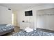 Bedroom with a dresser, television, closet, and decoratively folded towels atop the bed at 209 75Th Ave N # T-8, Myrtle Beach, SC 29572