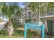 Sign for Ocean Dunes Resort & Villas I, set amidst lush landscaping with palm trees at 209 75Th Ave N # T-8, Myrtle Beach, SC 29572