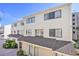 Charming multi-level townhouse with cream siding, dark window trim, and nicely maintained brick pathway at 209 75Th Ave N # T-8, Myrtle Beach, SC 29572