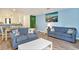 Inviting living room with comfortable blue sofas and a view into the adjacent dining area at 209 75Th Ave N # T-8, Myrtle Beach, SC 29572