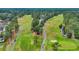 Aerial view of a golf course featuring a cart path, a pond, trees, and a green at 215 Lander Dr., Conway, SC 29526