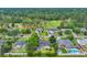 Aerial view showcases the home near a golf course, featuring a backyard patio set and detached garage at 215 Lander Dr., Conway, SC 29526