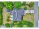 Aerial view of home with a dark roof, patio set, landscaping, detached garage, and a long driveway at 215 Lander Dr., Conway, SC 29526