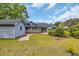 View of backyard with patio, green lawn, landscaping, detached garage and partial view of house at 215 Lander Dr., Conway, SC 29526