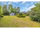 Large backyard with a detached garage, patio set, landscaping, and view of the house exterior at 215 Lander Dr., Conway, SC 29526