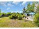 Expansive backyard featuring a patio set, mature landscaping, and a detached garage or storage building at 215 Lander Dr., Conway, SC 29526