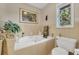Bathroom featuring a soaking tub, picture and a window offering natural light at 215 Lander Dr., Conway, SC 29526