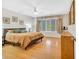 Well-lit bedroom featuring hardwood floors, a comfortable bed, and natural light at 215 Lander Dr., Conway, SC 29526
