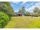 Brick home with lush green lawn and mature trees, offering curb appeal and a sense of privacy at 215 Lander Dr., Conway, SC 29526