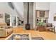 Bright living room featuring hardwood floors, a brick fireplace, and access to the backyard at 215 Lander Dr., Conway, SC 29526