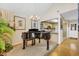 Grand piano adds elegance to living room with chandelier and bar seating into kitchen at 215 Lander Dr., Conway, SC 29526