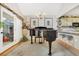 Grand piano anchors living space complete with chandelier and bar seating into kitchen at 215 Lander Dr., Conway, SC 29526