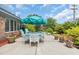 Outdoor patio features a dining table and chairs, lush landscaping, and a welcoming atmosphere at 215 Lander Dr., Conway, SC 29526