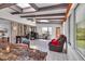 Bright sunroom with skylights, tile flooring, and a cozy seating area and work area at 215 Lander Dr., Conway, SC 29526
