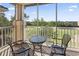 Relaxing screened-in balcony with golf course views, a table, and two chairs at 2180 Waterview Dr. # 1044, North Myrtle Beach, SC 29582