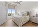 Bright bedroom with large window, stylish ceiling fan, and hardwood floors at 2180 Waterview Dr. # 1044, North Myrtle Beach, SC 29582