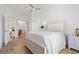 Bright bedroom with hardwood floors features an ensuite bathroom and neutral color palette at 2180 Waterview Dr. # 1044, North Myrtle Beach, SC 29582