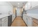 Galley kitchen showcasing modern appliances, custom cabinets, and a beautiful backsplash at 2180 Waterview Dr. # 1044, North Myrtle Beach, SC 29582