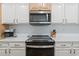Bright kitchen features white cabinets, subway tile backsplash, and stainless steel appliances at 2180 Waterview Dr. # 1044, North Myrtle Beach, SC 29582