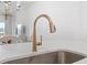 Close-up of a modern kitchen sink with a stylish gold faucet and white countertops at 2180 Waterview Dr. # 1044, North Myrtle Beach, SC 29582