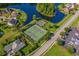 Aerial view of neighborhood tennis and basketball courts surrounded by green spaces and well-manicured lawns at 235 Welcome Dr., Myrtle Beach, SC 29579