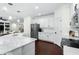 Bright eat-in kitchen features stainless appliances, white cabinetry, and opens to living area at 235 Welcome Dr., Myrtle Beach, SC 29579